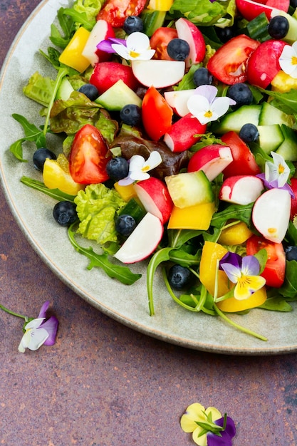 Tasty summer salad with edible flowers