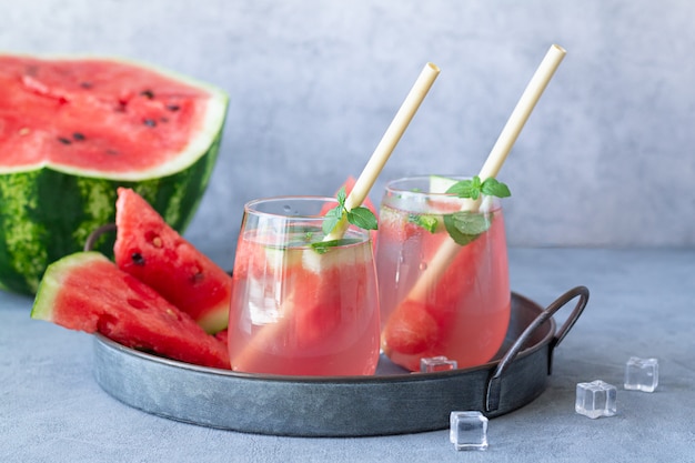 Tasty summer watermelon lemonade in two glasses on stone table