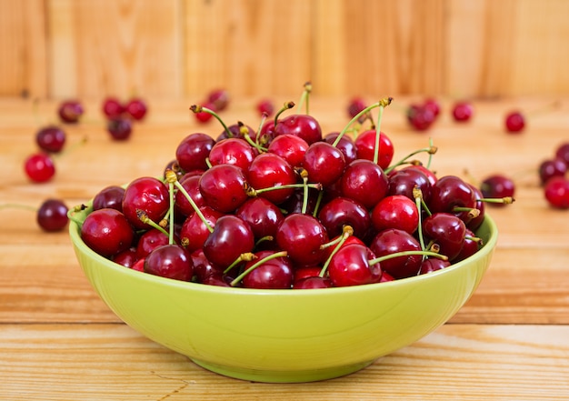 Tasty sweet cherry on wooden