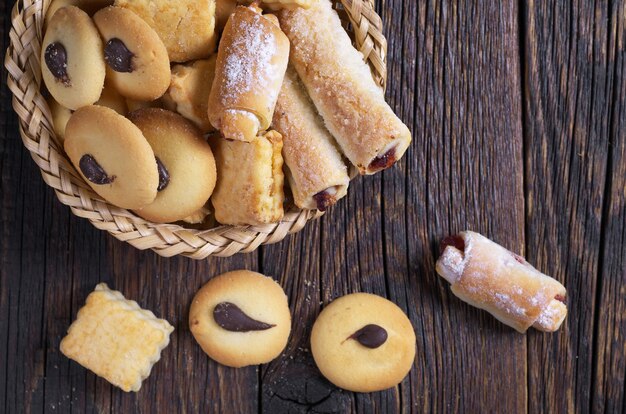 Tasty sweet cookies on dark wooden table, top view