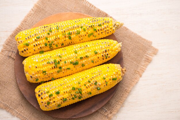 Tasty sweet grilled corn with onion sauce