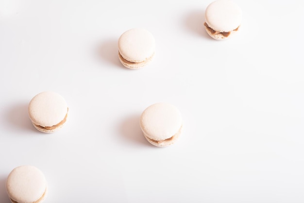 Tasty sweet macarons Macaroons on white background Top view Copy space