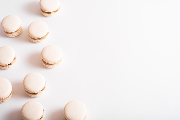 Tasty sweet macarons Macaroons on white background Top view Copy space
