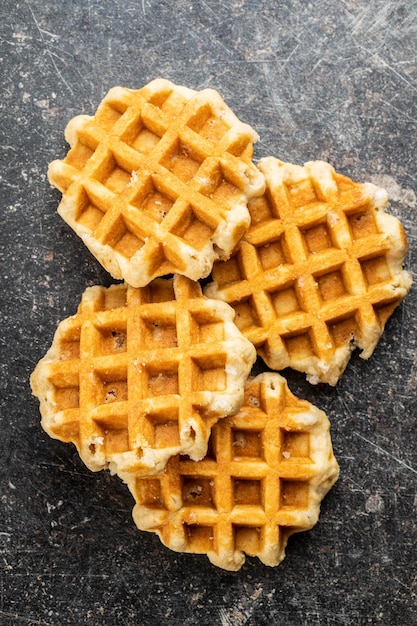 tasty sweet waffles on old kitchen table top view