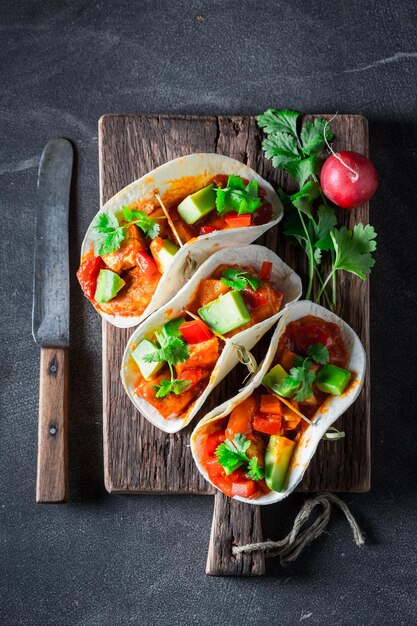 Tasty tacos with avocado lime and tomato sauce