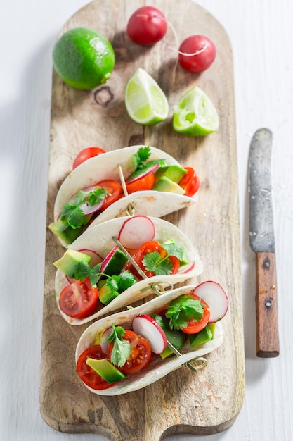 Tasty tacos with cherry tomatoes and radish