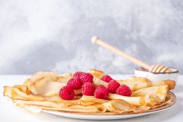 Tasty thin pancakes with fresh raspberry. Space for text