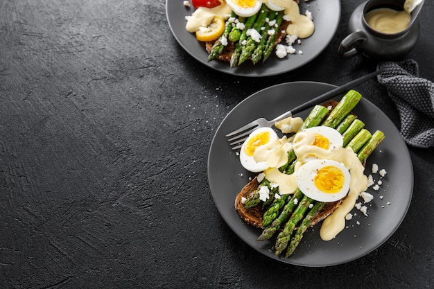 Tasty toasts with asparagus, eggs and sauce