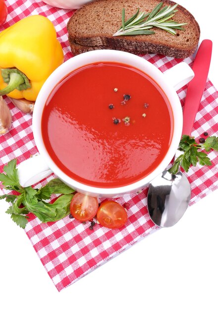 Tasty tomato soup and vegetables isolated on white