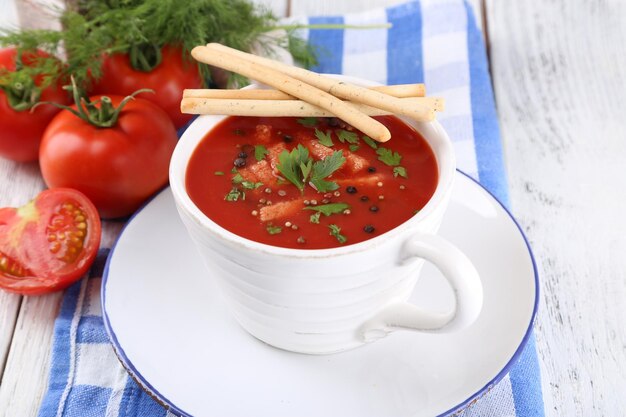 Tasty tomato soup with croutons on table closeup