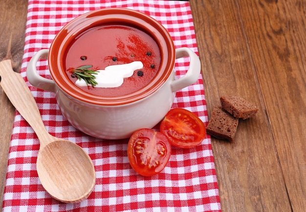 Tasty tomato soup on wooden table