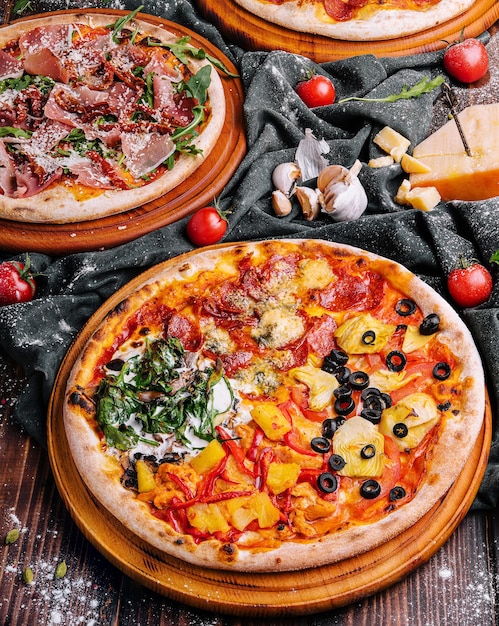 Tasty two pizzas on a wooden background