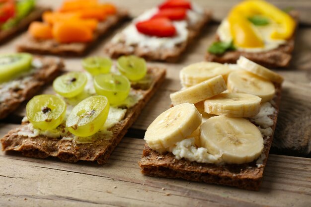 Tasty vegetarian sandwiches on wooden table