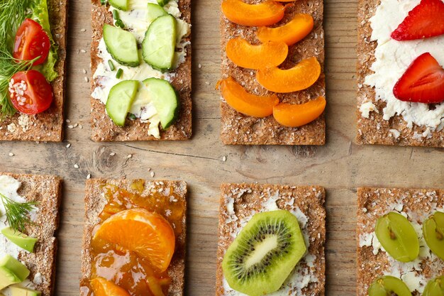 Tasty vegetarian sandwiches on wooden table