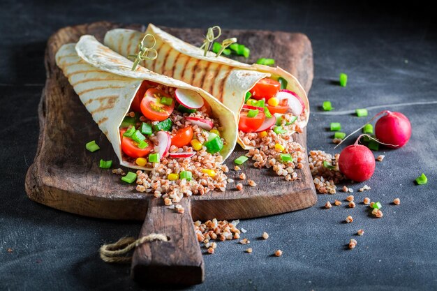 Tasty vegetarian tortilla with fresh vegetables and groats