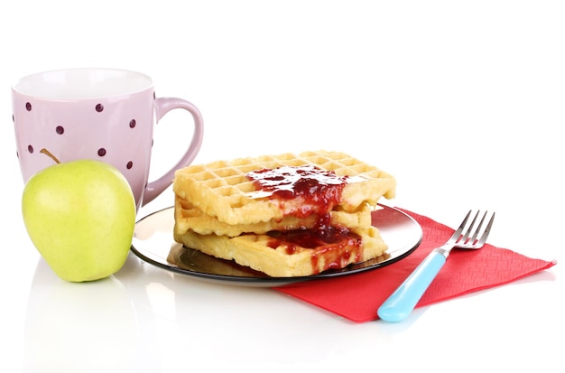 Tasty waffles with jam on plate isolated on white