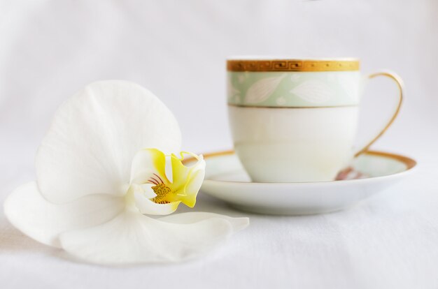 Tasty white porous chocolate and cup of coffee