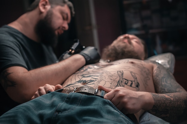 Tatoeëerder toont proces van het maken van een tatoeage