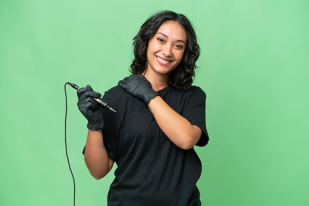 Tattoo artist Argentinian woman over isolated background laughing