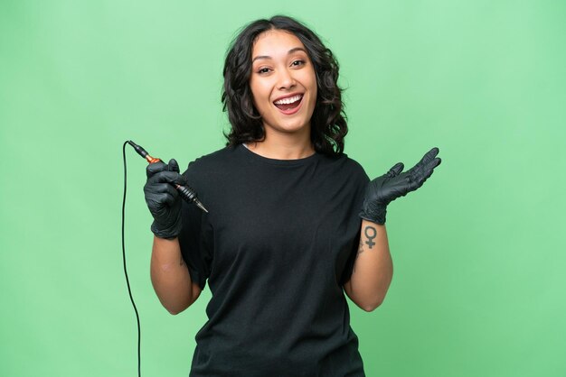 Tattoo artist Argentinian woman over isolated background with shocked facial expression