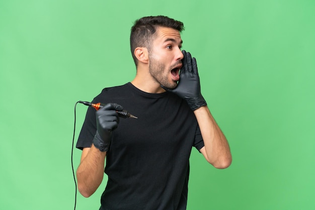 Tattoo artist caucasian man over isolated background shouting with mouth wide open to the side