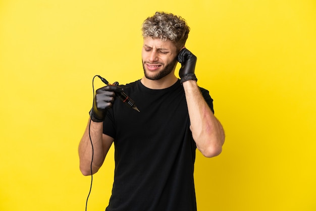 Tattoo artist caucasian man isolated on yellow background frustrated and covering ears