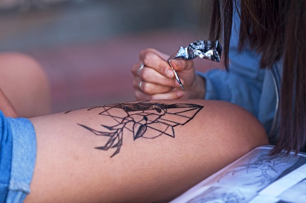 Tattoo artist drawing a deer head