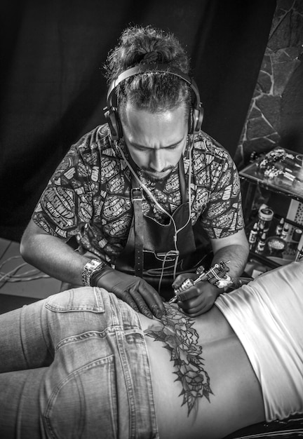 Tattoo artist formulates a tattoo tattoo studio