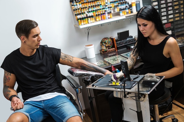 Tattoo artist during her work