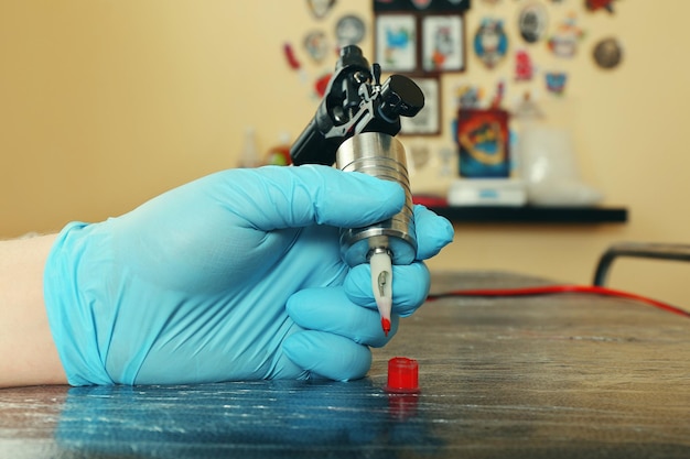 Tattoo artist at work close up