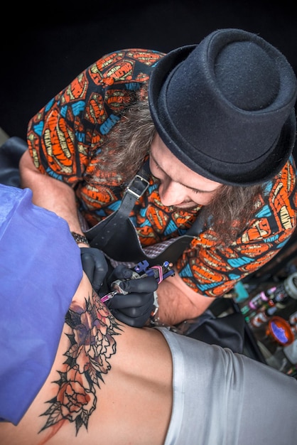 Photo tattoo master makes tattoo pictures in studio.