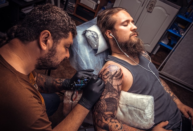 Tattoo specialist makes cool tattoo in tattoo salon