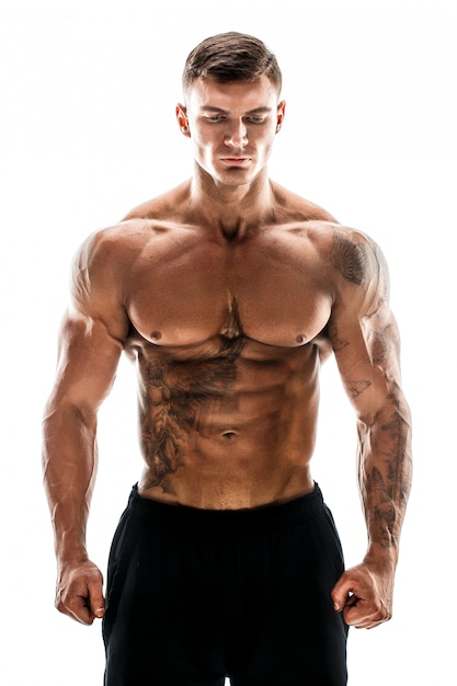 tattooed muscular super high level handsome man posing in studio isolated on white scene