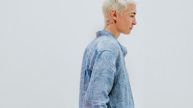 Tattooed woman in a blue linen shirt