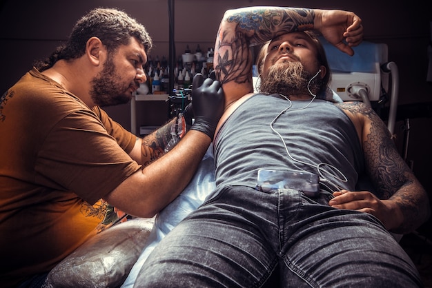 Tattooer는 문신 스튜디오에서 문신 사진을 만듭니다.