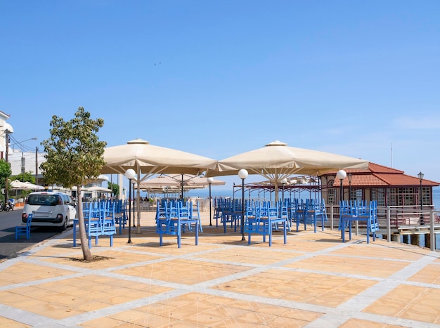 Tavern without customers amid a coronavirus pandemic on the waterfront of resort town in Greece