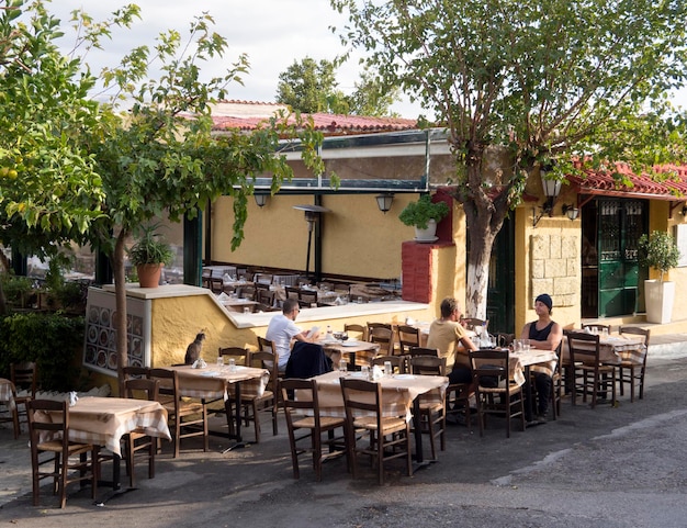 Taverns in the Greek tourist district of Plaka at the foot of the Acropolis in Athens Greece