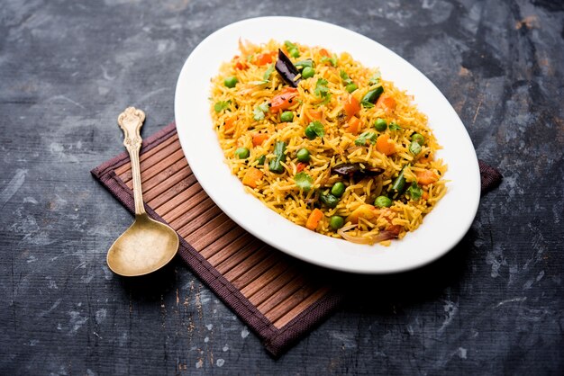 Tawa Pulao or Pulav or Pilaf or Pilau is an Indian Street Food  made using basmati rice, vegetables and spices. Selective focus