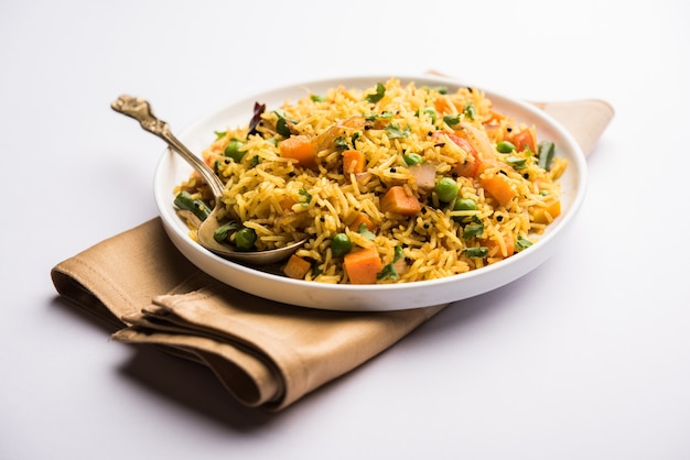 Tawa Pulao or Pulav or Pilaf or Pilau is an Indian Street Food  made using basmati rice, vegetables and spices. Selective focus