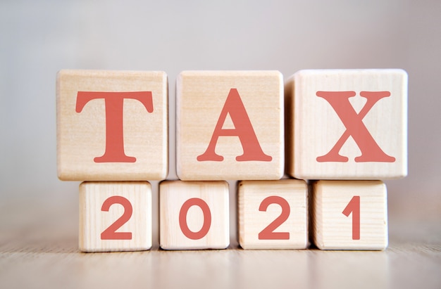 tax 2021 on wooden cubes, on wooden background.