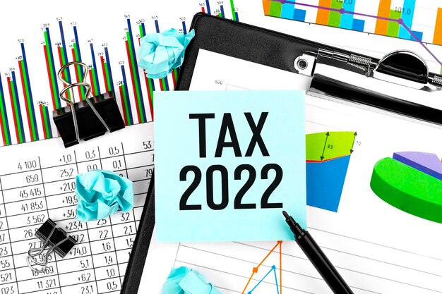 Tax 2022. Sticker, chart, clipboard. Business and tax concept. Flat lay.