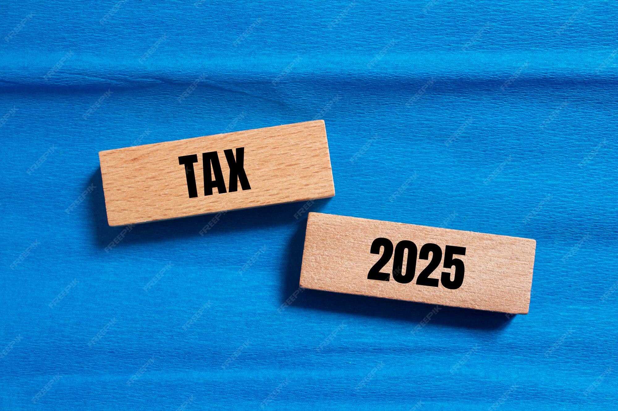 Premium Photo Tax 2025 words written on wooden blocks with blue background Conceptual tax 2025