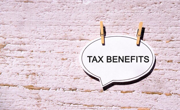 Tax benefits on a white sheet with wooden pins