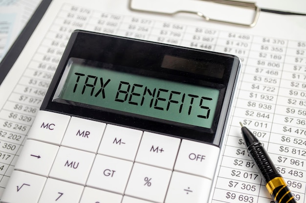 TAX BENEFITS word on calculator Business and tax concept
