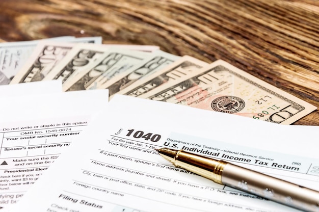 Photo tax form 1040 with pen and money on the table