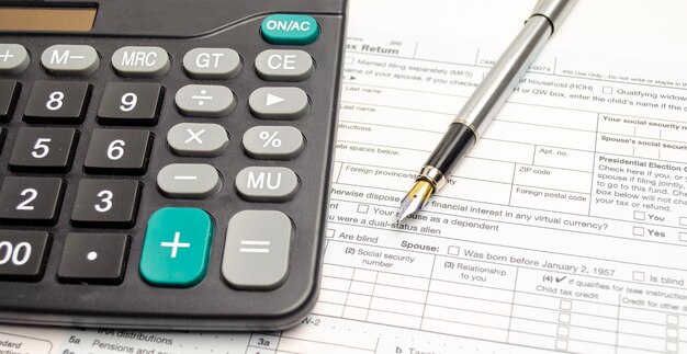 Tax form pen and calculator Tax concept