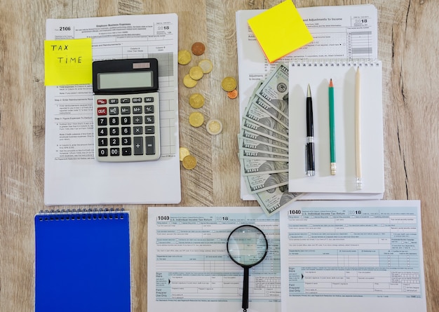 tax forms 1040 with stationery on the table