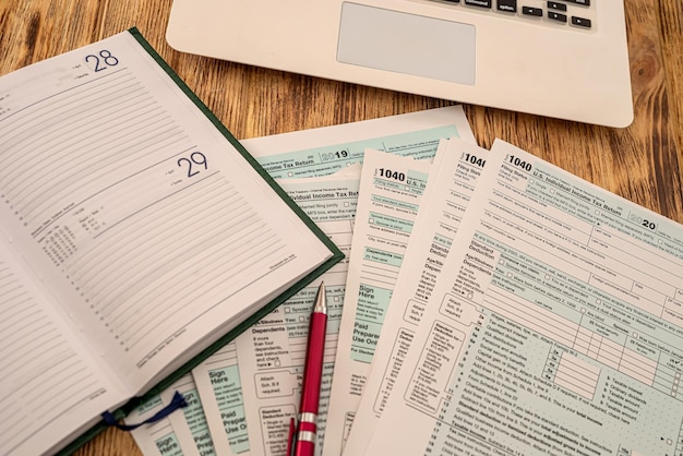 tax forms of the united states of america 1040 are ready to be filled by citizens of the usa with a pen lying on the table. documentation concept