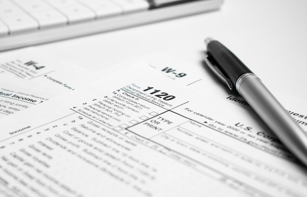 The tax forms with money and the pen. tax day concept.