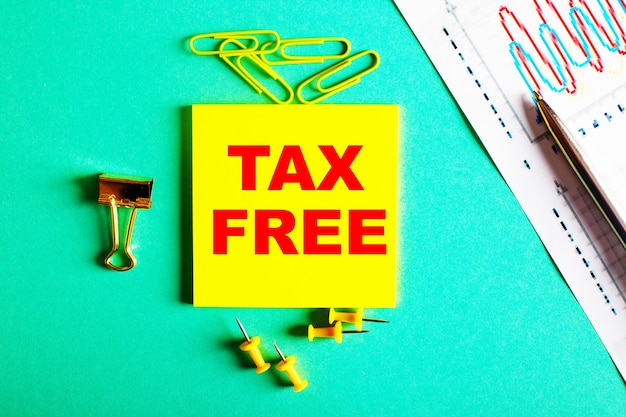 Tax free is written in red on a yellow sticker on a green wall near the graph and pencil